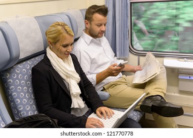 Woman with laptop man newspaper in train texting commuting reading