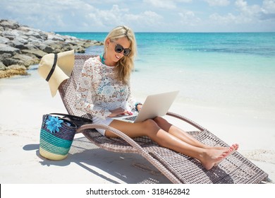 Woman With Laptop On The Beach