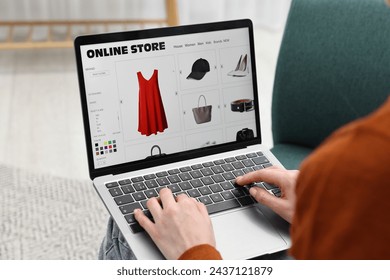 Woman with laptop shopping online at home, closeup