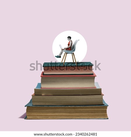 A woman with a laptop sits on a stack of books.