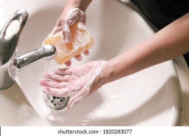 Woman With Large Bar Of Soap Washing Her Hands