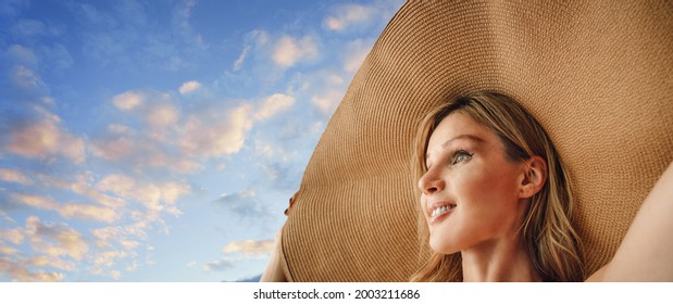 A Woman With A Large Sun Hat Protects The Sky - Vacation Concept