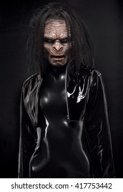 Woman In Latex Clothes With Ape Mask On Face