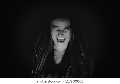 Woman Laughing Hysterically In The Dark