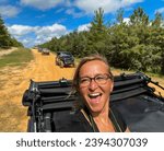 Woman laughing from the top of a Jeep while trail riding