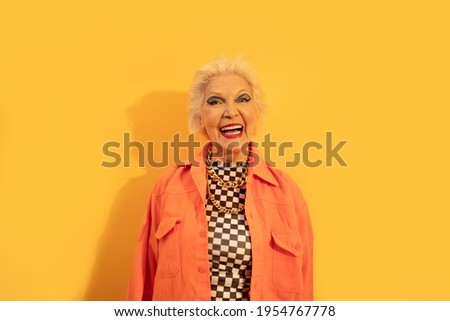 Woman laughing while being happy to spend free time at the studio