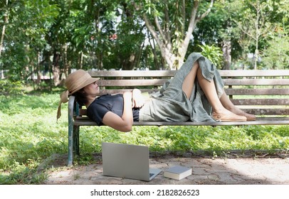 Woman Laying Down On Old Bench ,woven Hat Closed Her Eyes,for Relax Time ,in A Park