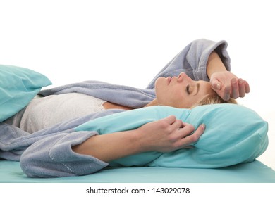 A Woman Laying In Her Bed Asleep With Her Arm Over Her Head