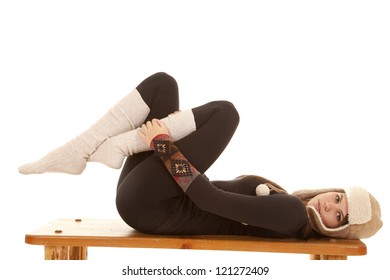 A Woman Laying On Her Bench In Her Warm Long Johns, Long Socks And A Warm Hat.