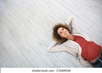 Woman laying on wooden modern flooring