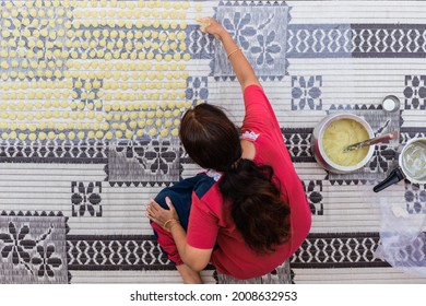 Woman Laying Sendige Dough On Sheets For Drying In The Sun, Top Down View. Indian Snacks Similar To Papads. Small Scale Food Businesses.