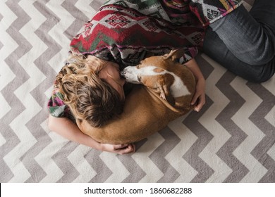 Woman Lays Down With A Dog And Hugs Her. Emotional Support, Depression And Stress Relief With Pets During Lockdown And Stay At Home Orders