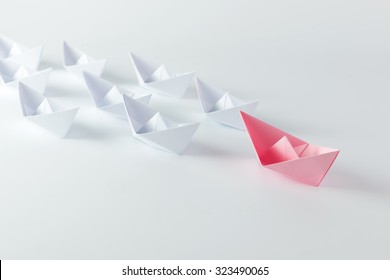 Woman Leadership Concept With Pink Paper Ship Leading Among White