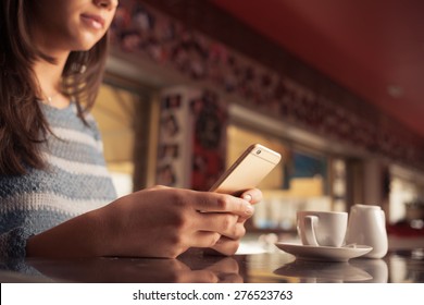 Woman Leaning On The Bar Counter And Text Messaging With Her Mobile, Hands Close Up