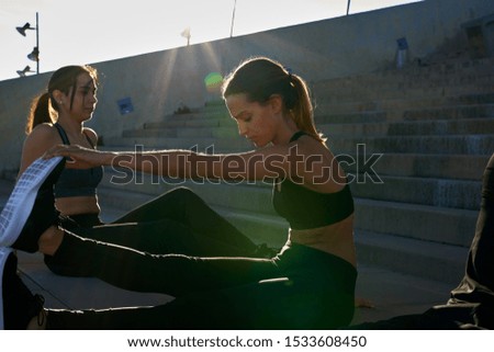 Woman leans forward and grabs her toes as she stretches her leg muscles