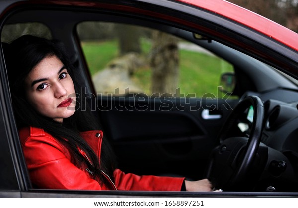 Woman learning to drive\
the car - image