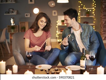 Woman learning how to eat with chopsticks  - Powered by Shutterstock