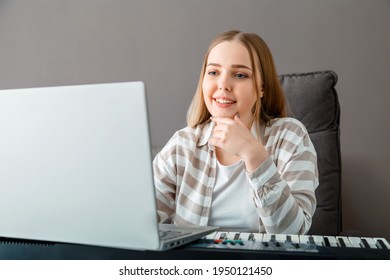 Woman Learns To Play Piano Online Using Laptop. Woman Plays Keyboard Instrument On Synthesizer Piano During Online Lesson With Teacher. Online Concert Stream Performer For Online Audience In Laptop