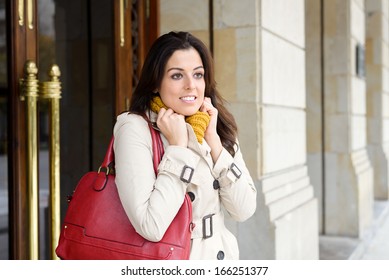 Woman Leaving Apartment Building Entrance Door For Going To Work Outside In Cold Day. Winter Or Autumn City Life Scene.