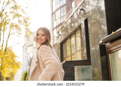 Woman Leaving Home To Work In The Early Morning Against Warm Sunlight. Beautiful Girl Looking Back Over Her Shoulder On The Street