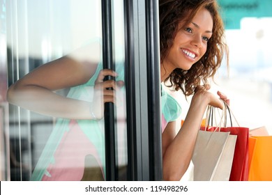 Woman Leaving A Store With Shopping Bags