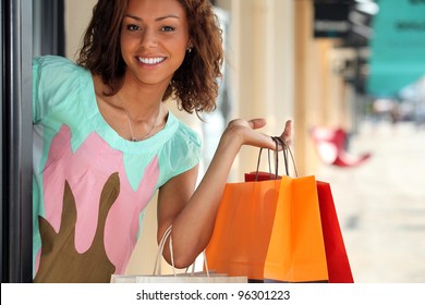 Woman Leaving Store With Shopping Bags