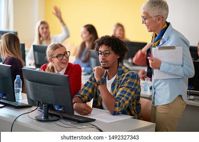 Woman lecturer in computer class assisting multi-ethnic student on university campus
 - Powered by Shutterstock