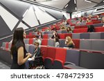 Woman lecturing students in a university lecture theatre