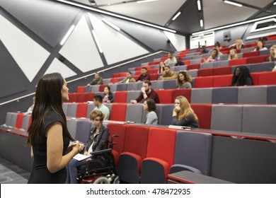Woman Lecturing Students In A University Lecture Theatre
