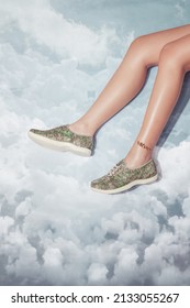 Woman legs with anklet in stylish lumina sage sneakers isolated on blue cloud sky background, space for text
