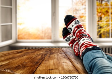 Woman Legs With Autumn Socks And Open Fall Window. Wooden Board Of Free Space For Your Decoration And Golden Leaves. 