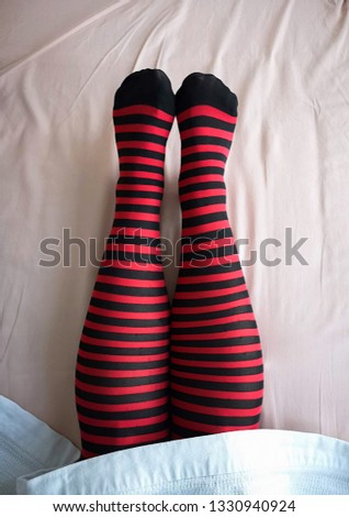 woman legs with black and red striped stockings