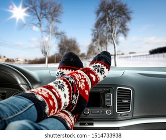 Woman Legs With Chrismtas Socks And Car Interior 