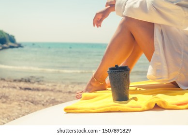 Woman Legs With Coffee Cup At Car Hood Sea Summer Beach