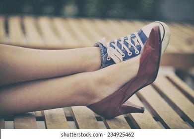 Woman Legs In Different Shoes