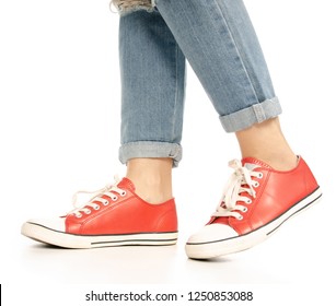 Woman Legs Feet Jeans Red Sneakers Hipster Style, Side View On A White Background. Isolation