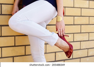 Woman Legs In High Heel Shoes Outdoor Shot Near Wall , White Pants