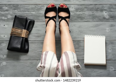 Woman Legs In A High Heels Shoes, Clutch Bag And A Blank Page Notepad. Women Tips. Female Tricks Mock Up. 