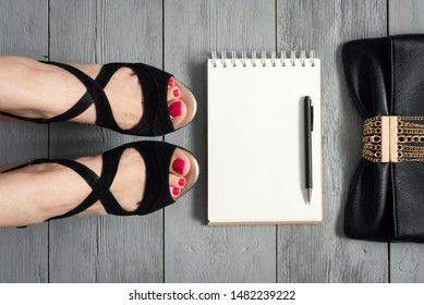 Woman Legs In A High Heels Shoes, Clutch Bag And A Blank Page Notepad. Women Tips. Female Tricks Mock Up. 