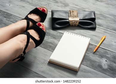 Woman Legs In A High Heels Shoes, Clutch Bag And A Blank Page Notepad. Women Tips. Female Tricks Mock Up. 