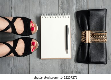 Woman Legs In A High Heels Shoes, Clutch Bag And A Blank Page Notepad. Women Tips. Female Tricks Mock Up. 