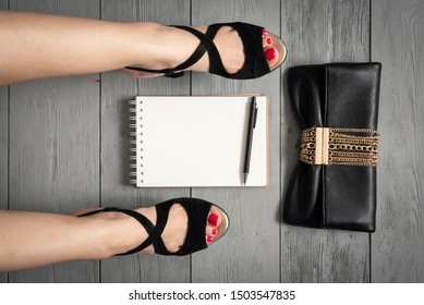 Woman Legs In A High Heels Shoes, Clutch Bag And A Blank Page Notepad. Women Tips. Female Tricks Mock Up. 