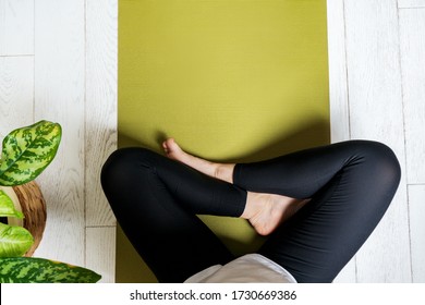 Woman Legs On An Exercise Mat. Female Preparing Practicing Yoga At Home. National Yoga Day. Healthy Living In Lockdown.