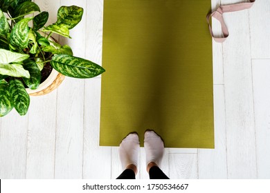 Woman legs on an exercise mat with copy space. Preparing to do yoga at home. Female practicing yoga. Healthy living in lockdown. - Powered by Shutterstock