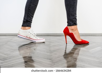 Woman legs on grey background. On one feet wearing casual white sneakers, and on other elegant red high heels. Combination for day and night on one photography. - Powered by Shutterstock - Get 15% off with code: PIKWIZARD15