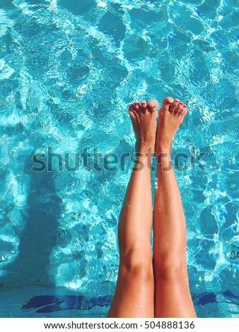 Woman legs on pool side