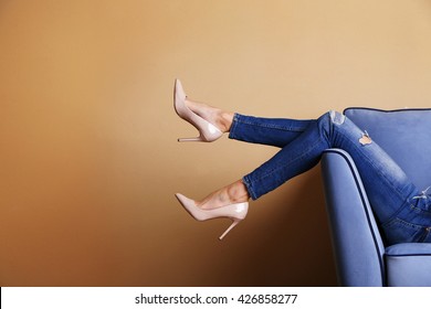 Woman Legs On Sofa With Stylish Shoes In Room 