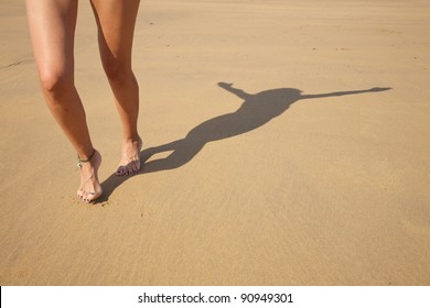 Woman Legs And Shade With Compass In A Beach