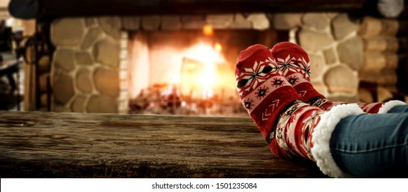 Woman legs with socks and christmas fireplace  - Powered by Shutterstock