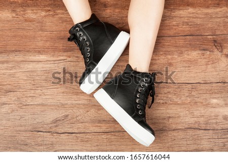 Woman legs in sport shoes.